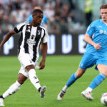 TURIN, ITALY - SEPTEMBER 21: Pierre Kalulu of Juventus passes the ball under pressure from Scott McTominay of Napoli during the Serie A match between Juventus and Napoli at Allianz Stadium on September 21, 2024 in Turin, Italy. (Photo by Marco Luzzani/Getty Images)